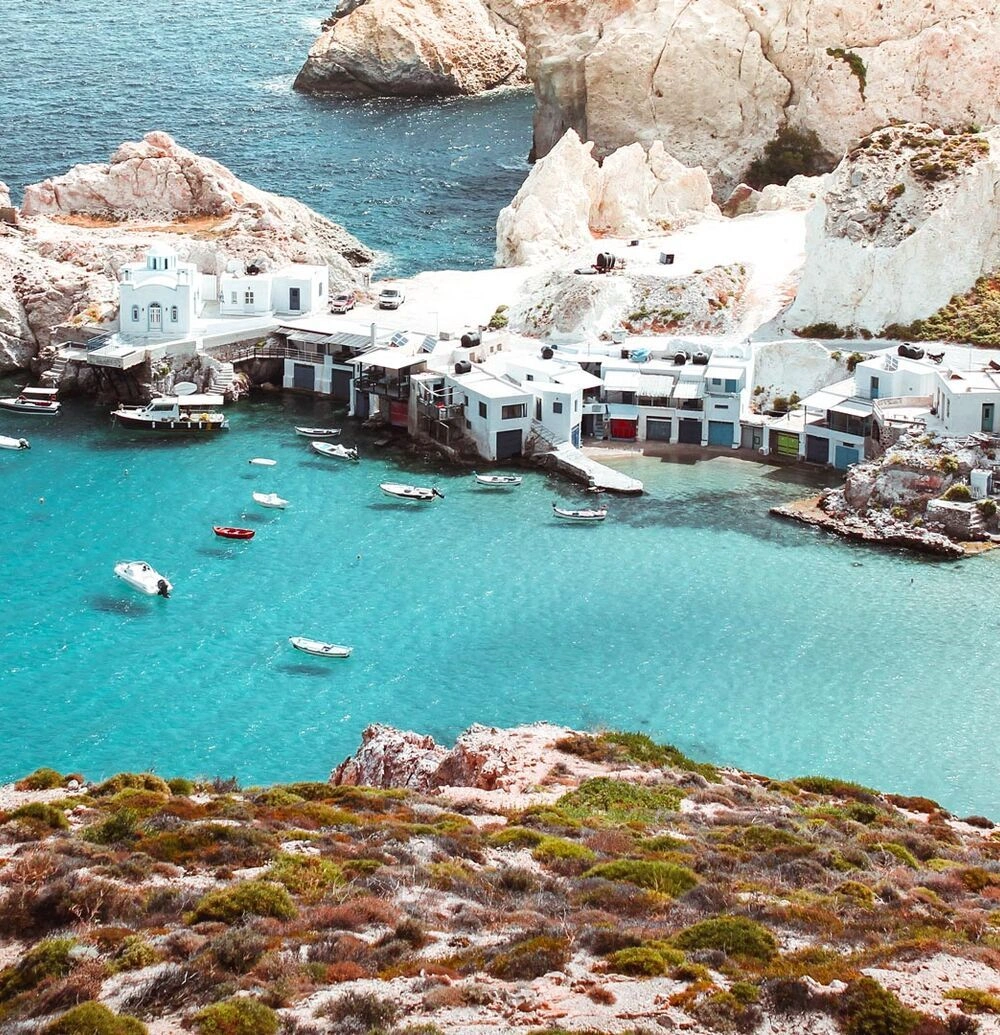 Milos island white cliffs, turquoise bays and Cycladic village in Greece
